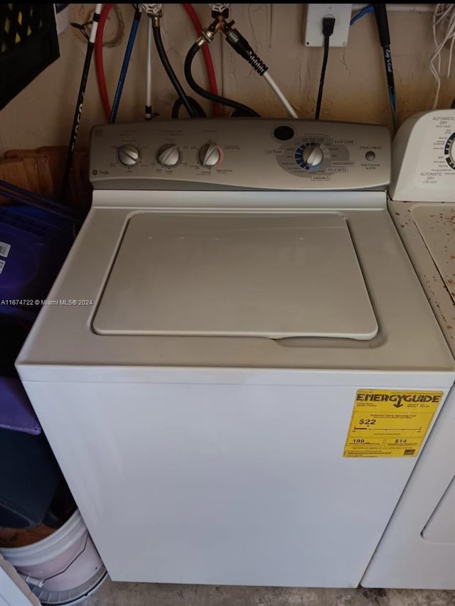 clothes washing area featuring washer and clothes dryer