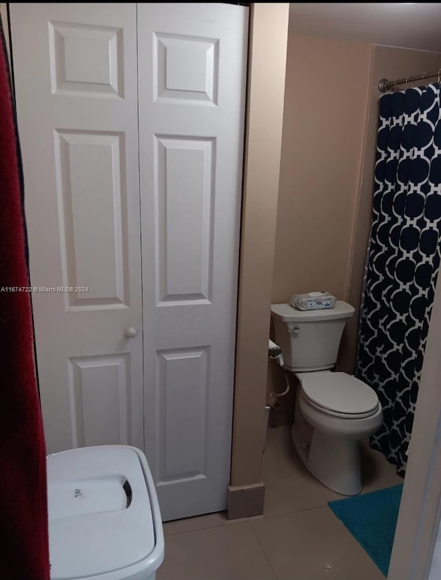 bathroom with toilet and tile patterned floors