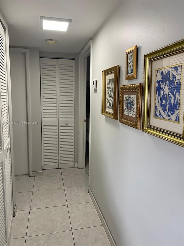 hall featuring light tile patterned flooring