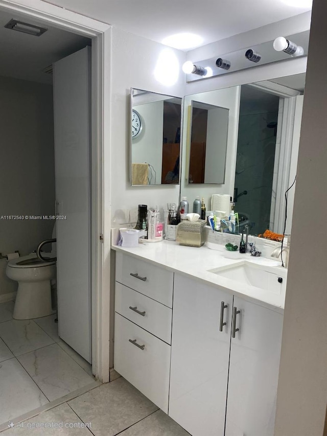 bathroom with toilet, tile patterned flooring, and vanity