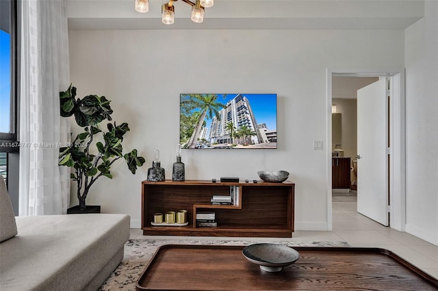 living room with light tile patterned floors and a chandelier