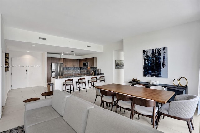 dining area featuring light tile patterned flooring