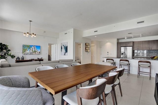 tiled dining area with a notable chandelier