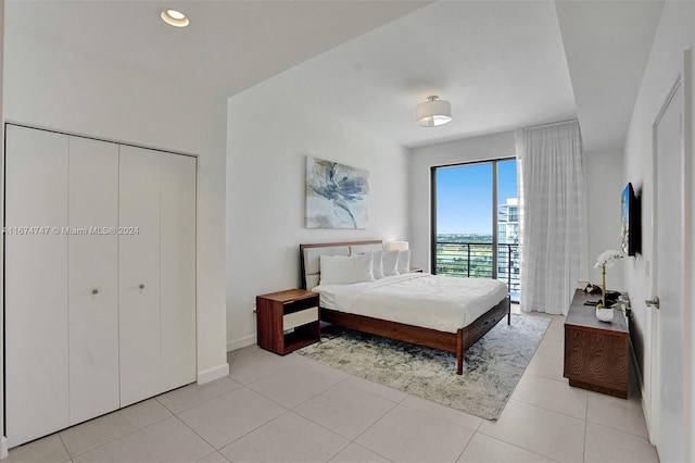 tiled bedroom featuring a closet