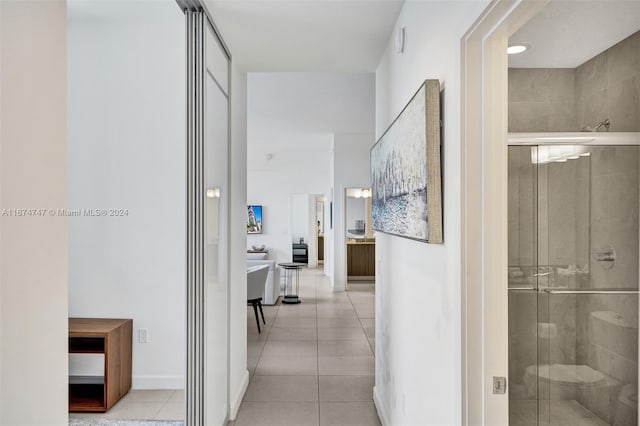 corridor with light tile patterned flooring