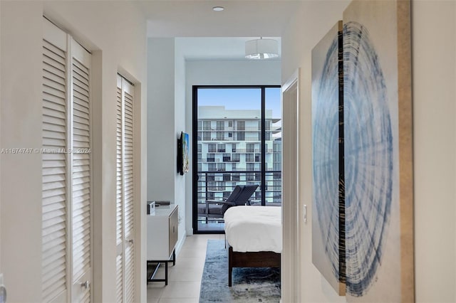 bedroom with light tile patterned floors and multiple windows