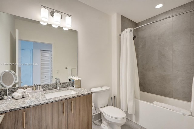 full bathroom with shower / bath combo with shower curtain, vanity, and toilet