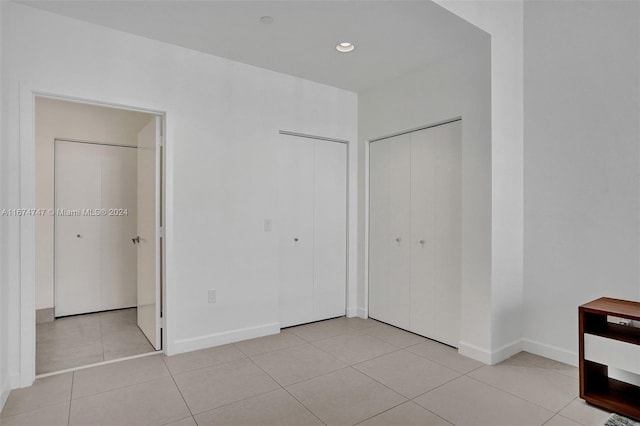 unfurnished bedroom featuring light tile patterned flooring