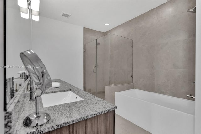 bathroom featuring separate shower and tub, tile patterned floors, and vanity