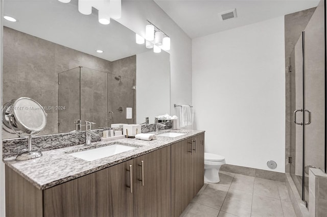 bathroom with an enclosed shower, tile patterned floors, vanity, and toilet