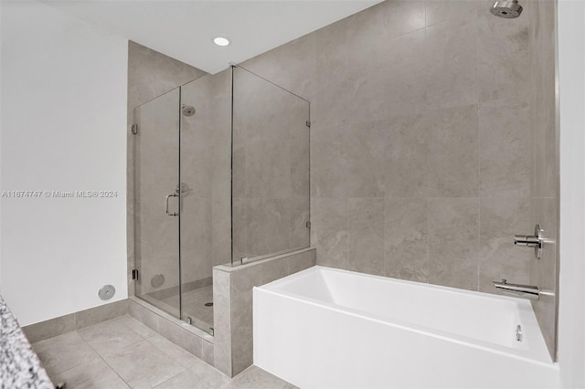 bathroom with tile patterned floors and independent shower and bath