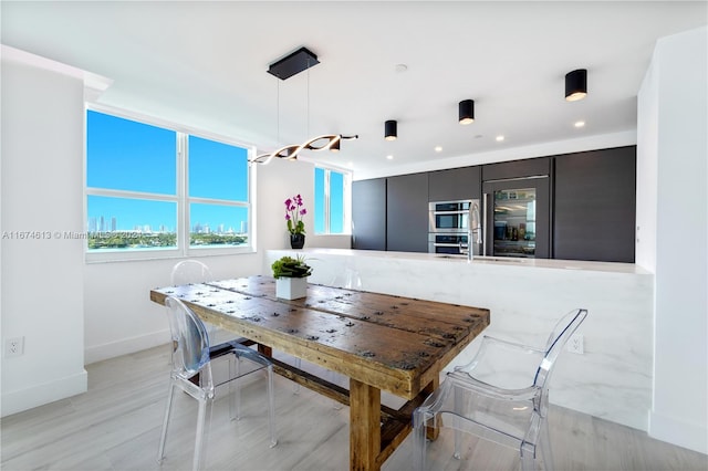 dining area featuring light wood-type flooring