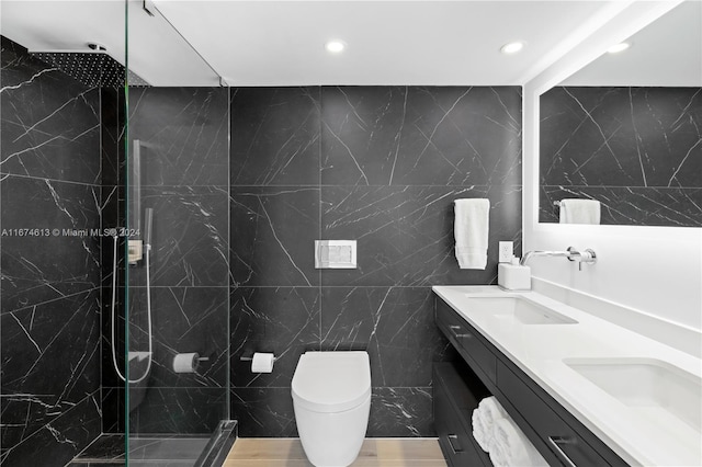 bathroom featuring vanity, wood-type flooring, tile walls, tiled shower, and toilet