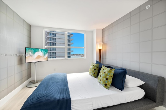 650 W Ave Unit 1101, Miami Beach, FL 33139 - bedroom with tile walls and wood finished floors