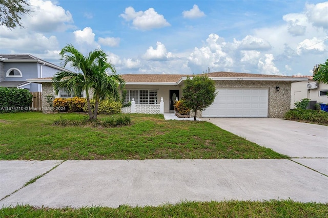 single story home featuring a front yard and a garage