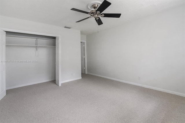 unfurnished bedroom featuring carpet flooring, a closet, and ceiling fan