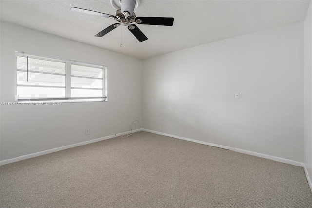 empty room featuring carpet and ceiling fan