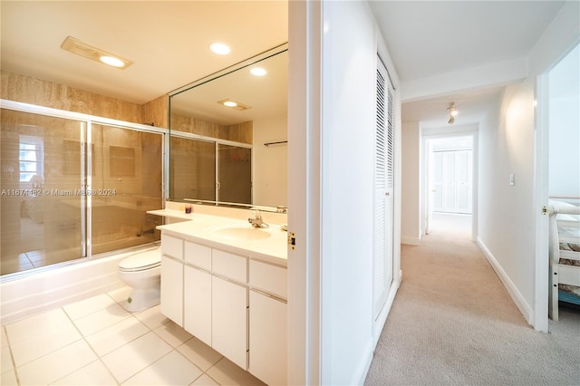 full bathroom with toilet, enclosed tub / shower combo, vanity, and tile patterned floors