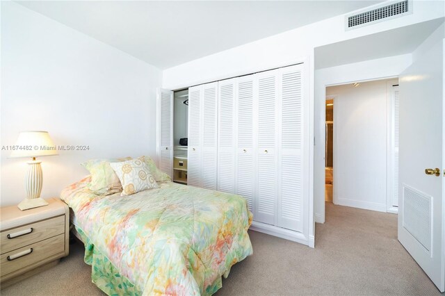 1408 Brickell Bay Dr Unit 1415 & 1416, Miami, FL 33131 - bedroom with light colored carpet, a closet, and baseboards