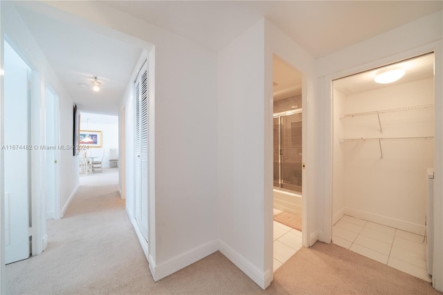 1408 Brickell Bay Dr Unit 1415 & 1416, Miami, FL 33131 - hallway featuring light carpet, light tile patterned floors, and baseboards