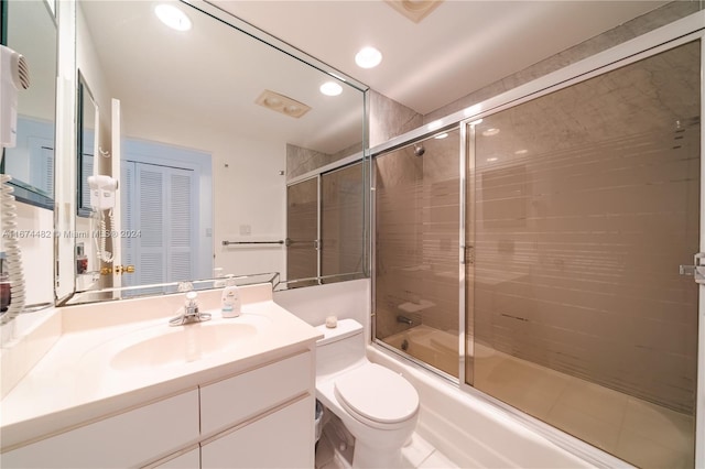 full bathroom featuring toilet, combined bath / shower with glass door, vanity, and tile patterned floors