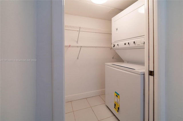 clothes washing area featuring stacked washer / dryer and light tile patterned floors