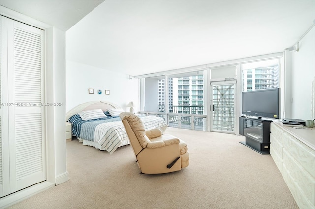 bedroom featuring access to outside and light colored carpet