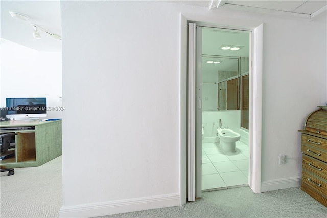 interior space featuring a shower with door, a bidet, and tile patterned flooring