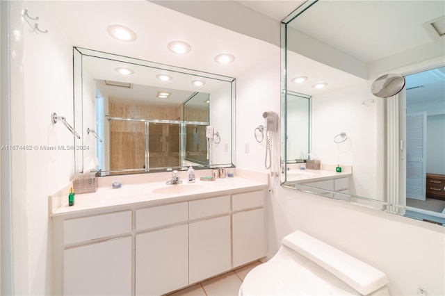 bathroom with vanity, an enclosed shower, toilet, and tile patterned flooring