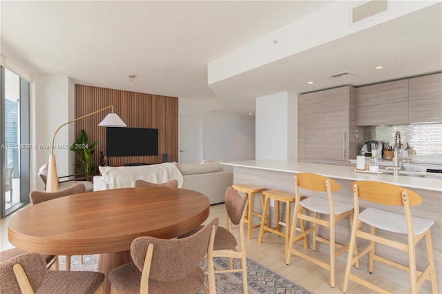 dining room featuring plenty of natural light, sink, and light hardwood / wood-style floors