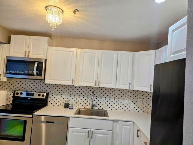 kitchen featuring white cabinetry, a sink, and appliances with stainless steel finishes