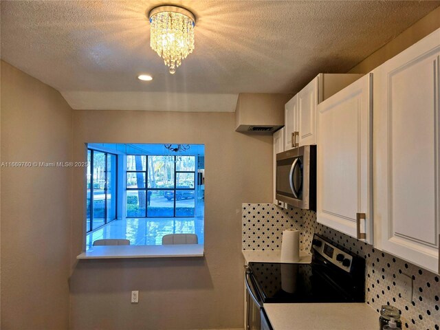 kitchen featuring tasteful backsplash, sink, white cabinets, light tile patterned floors, and stainless steel appliances