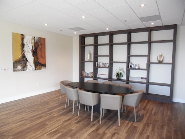 dining space featuring built in shelves, baseboards, and dark wood-type flooring