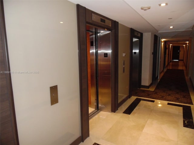 corridor featuring recessed lighting and elevator