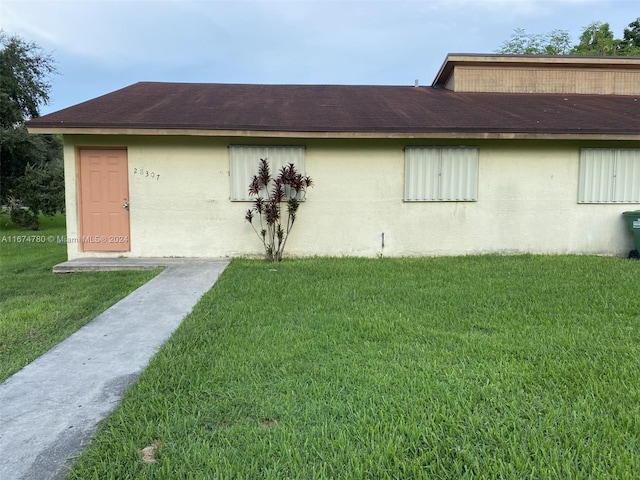 view of property exterior with a lawn