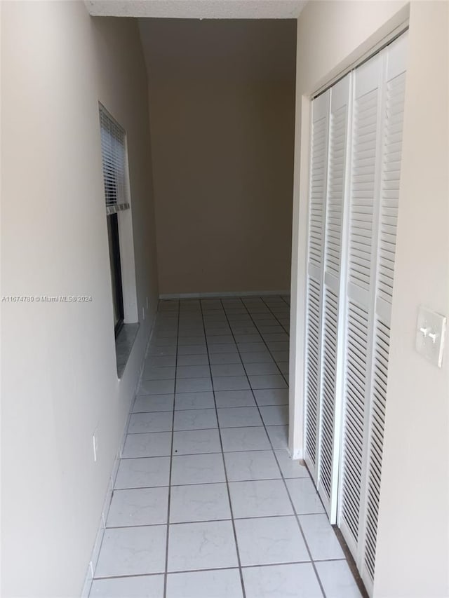 hallway with light tile patterned floors