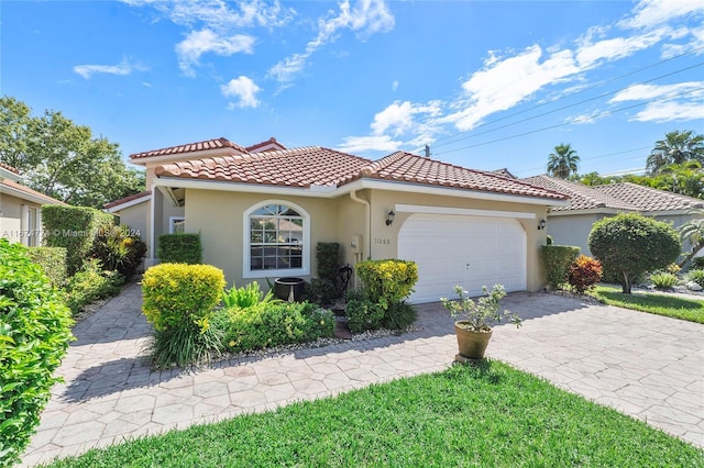 11088 Indian Lake Cir, Boynton Beach, FL 33437 - mediterranean / spanish-style house with a tiled roof, stucco siding, a garage, and decorative driveway