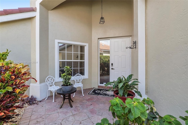 11088 Indian Lake Cir, Boynton Beach, FL 33437 - property entrance featuring stucco siding and a patio area