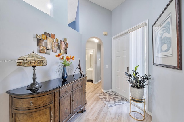 11088 Indian Lake Cir, Boynton Beach, FL 33437 - foyer featuring arched walkways, light wood-type flooring, and a high ceiling
