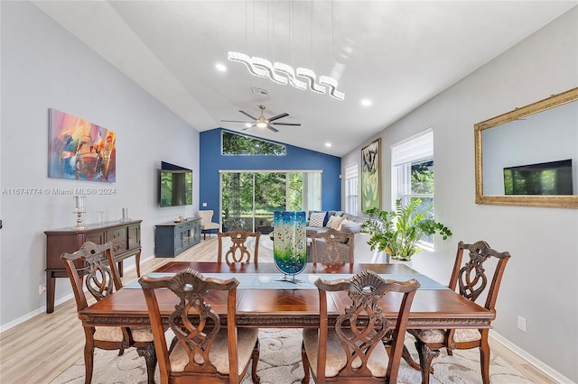 dining space featuring lofted ceiling, light wood-type flooring, and ceiling fan