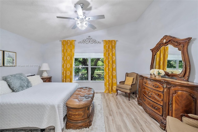 bedroom with lofted ceiling, light hardwood / wood-style flooring, multiple windows, and ceiling fan