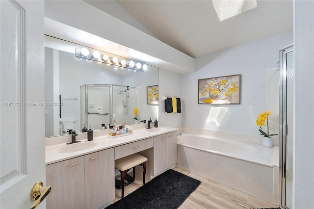 bathroom with hardwood / wood-style floors, separate shower and tub, and vanity