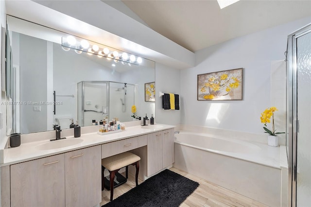 full bathroom with plus walk in shower, hardwood / wood-style floors, vanity, and toilet