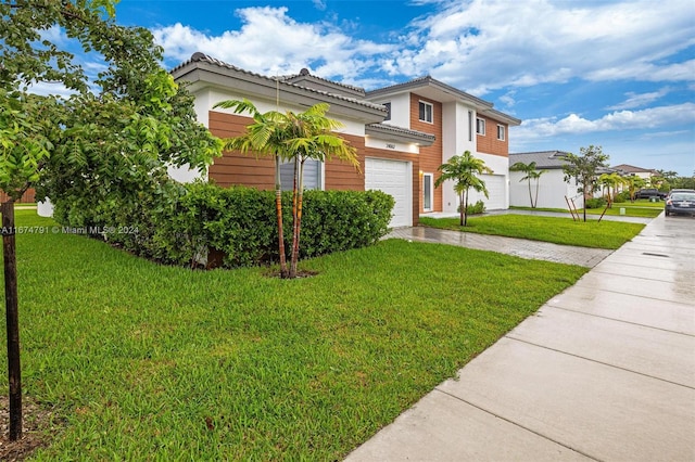 view of front of home featuring a front yard and a garage