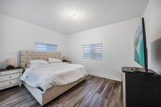 bedroom with dark hardwood / wood-style flooring