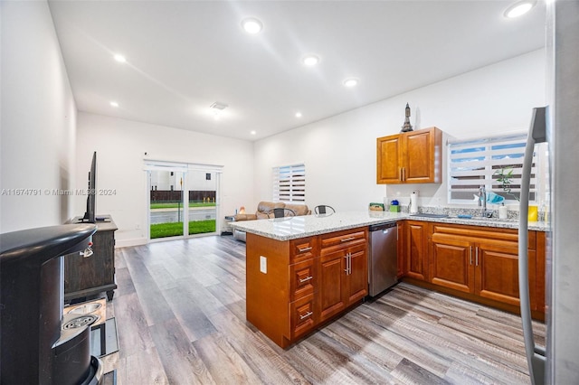 kitchen with light hardwood / wood-style floors, light stone countertops, sink, dishwasher, and kitchen peninsula