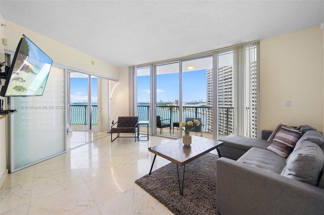 living room featuring a water view and floor to ceiling windows