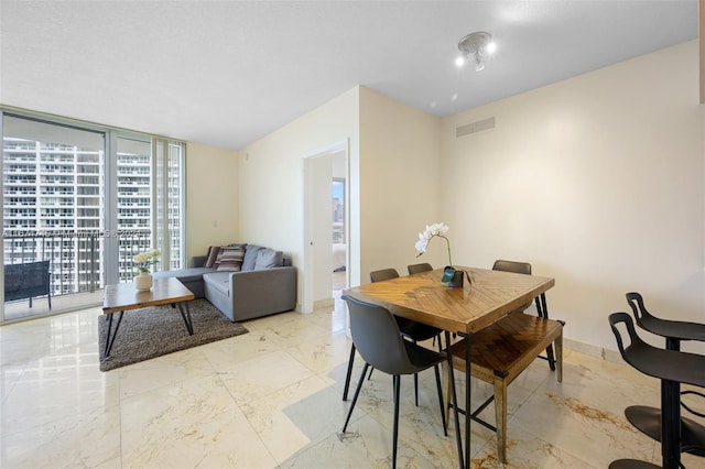 dining room with a wall of windows