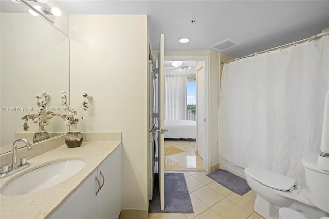 bathroom featuring tile patterned flooring, vanity, and toilet