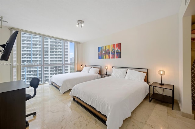 bedroom featuring floor to ceiling windows